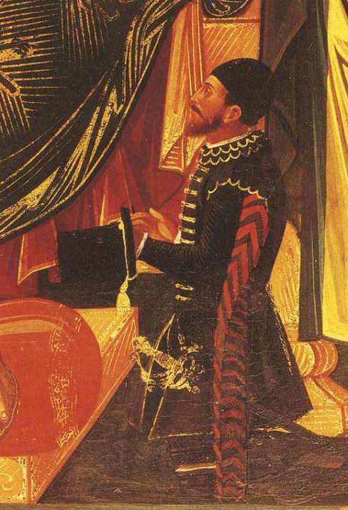 Ο Κομίνης Μάνεσης δεόμενος γονατιστός μπροστά στον ένθρονο Χριστό. Φοράει σκούφο, "καλογερικό" όπως τον λένε, και στο χέρι του κρατάει το "ψηλό καπέλο", χαρακτηριστικό των Stratioti. Aπο ‘Παράξενοι Φτωχοί Στρατιώτες’